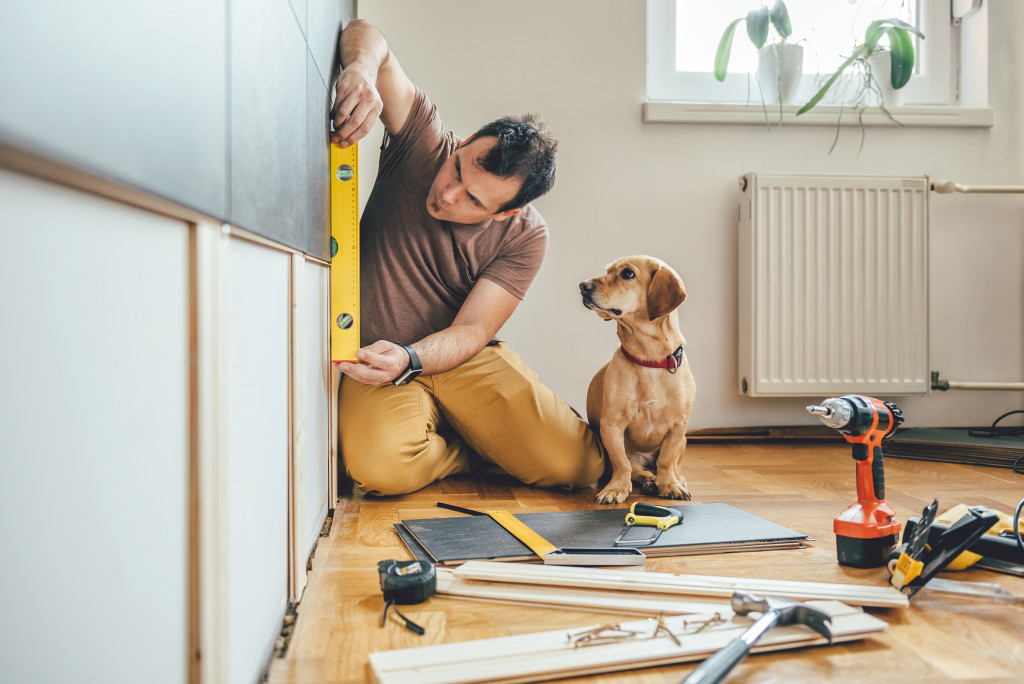 dog sitting next to its owner doing work